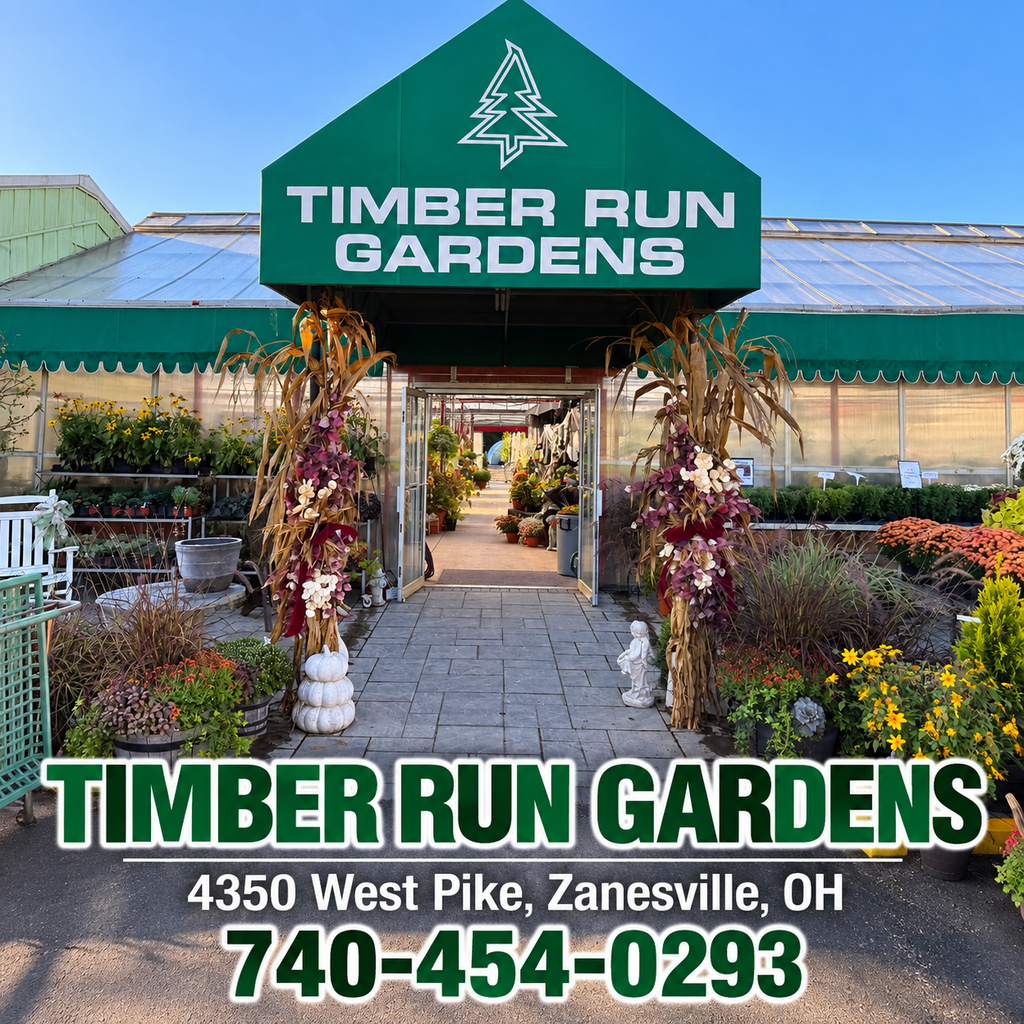The entrance to Timber Run Gardens plant nursery, featuring a greenhouse, fall floral arrangements, and contact information including the address and phone number.